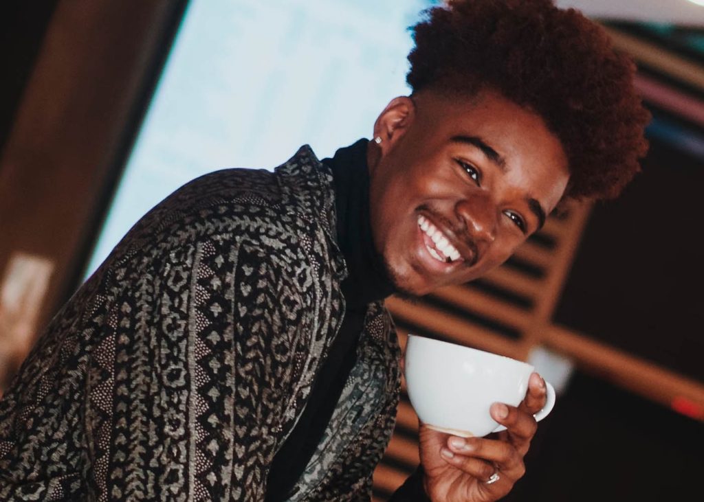 Smiling man holding a cup of coffee